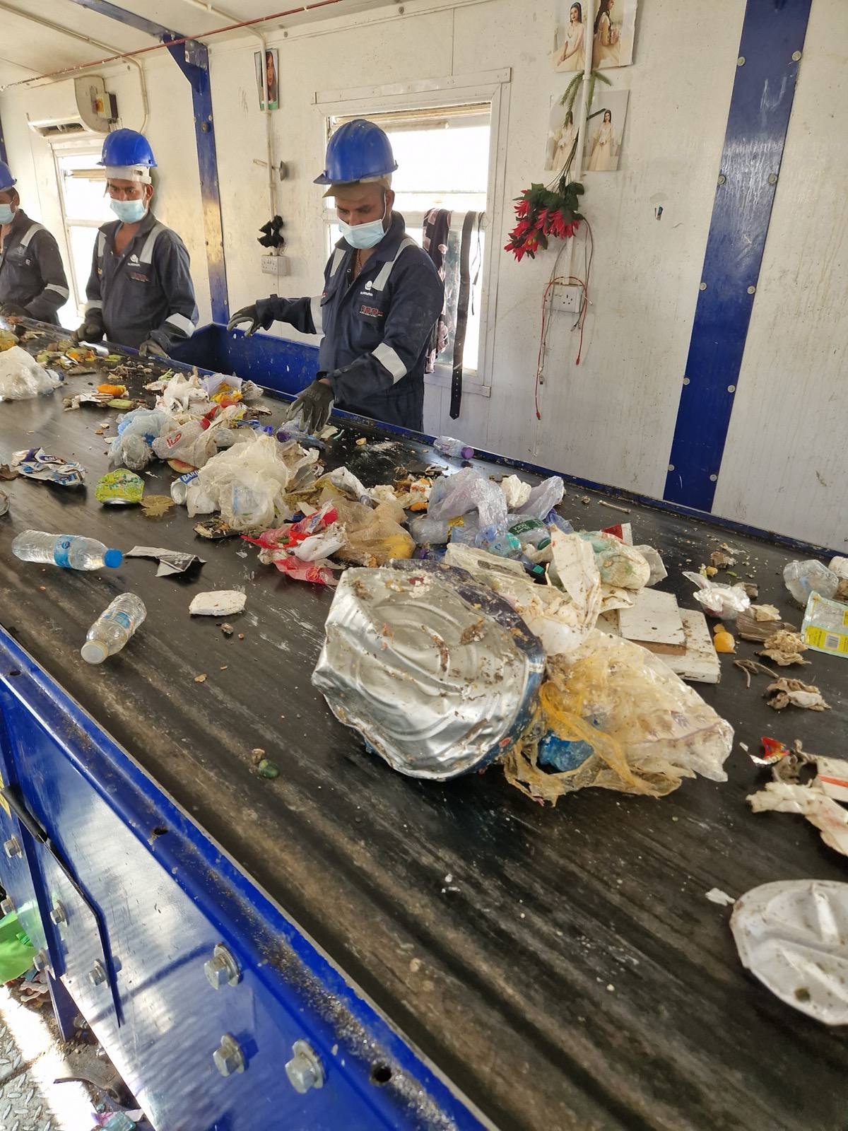Workers sorting recyclable materials at Marat RDF facility